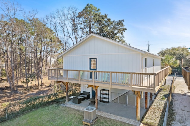 rear view of house featuring central air condition unit, a patio, a wooden deck, and an outdoor hangout area