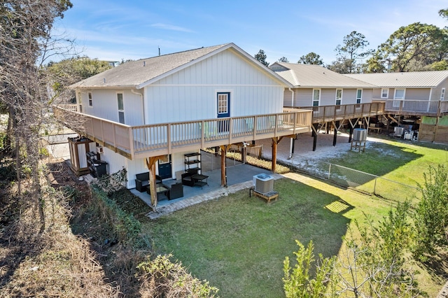 rear view of house featuring a patio, fence, a deck, a yard, and central AC