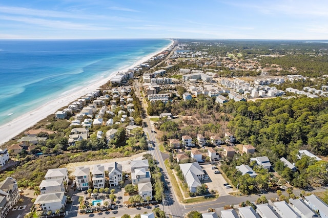 birds eye view of property featuring a water view, a residential view, and a view of the beach