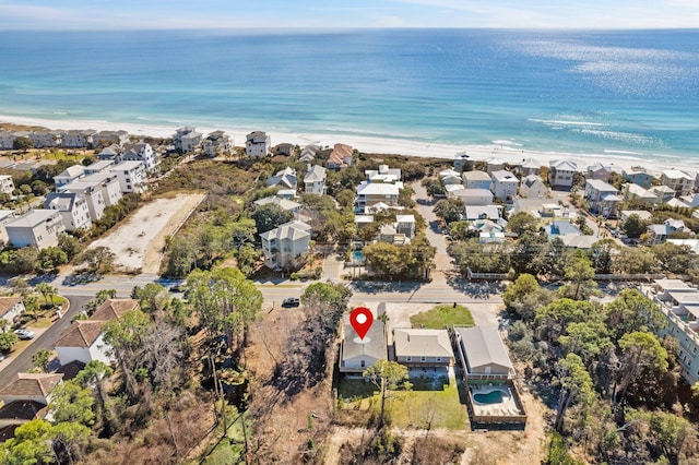 bird's eye view with a view of the beach, a water view, and a residential view