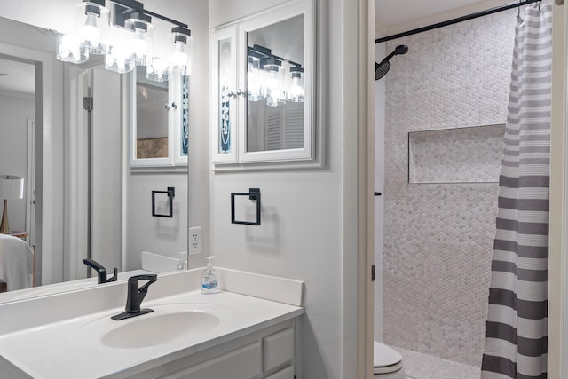 bathroom featuring toilet, a chandelier, a shower with shower curtain, and vanity