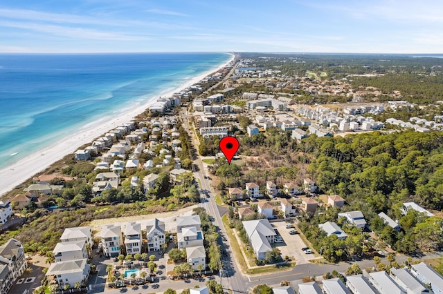 birds eye view of property with a water view, a beach view, and a residential view