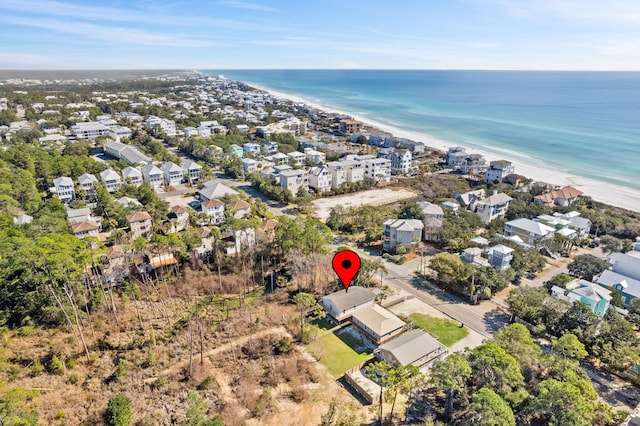 birds eye view of property with a water view, a view of the beach, and a residential view