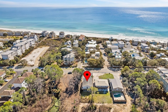 aerial view with a view of the beach, a residential view, and a water view