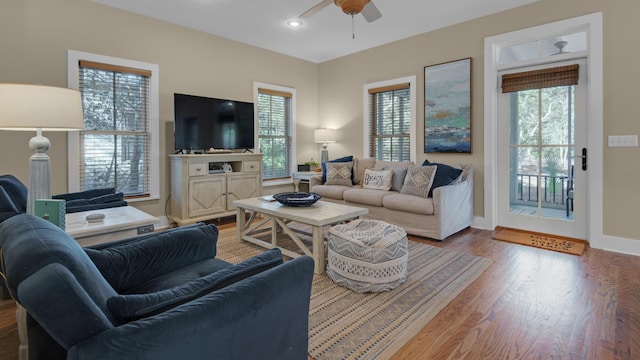 living area featuring recessed lighting, ceiling fan, baseboards, and wood finished floors