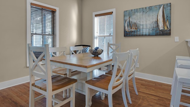 dining space with wood finished floors and baseboards