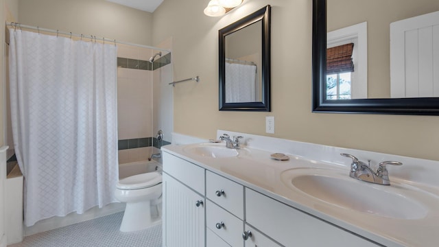 bathroom featuring shower / bath combination with curtain, a sink, toilet, and double vanity