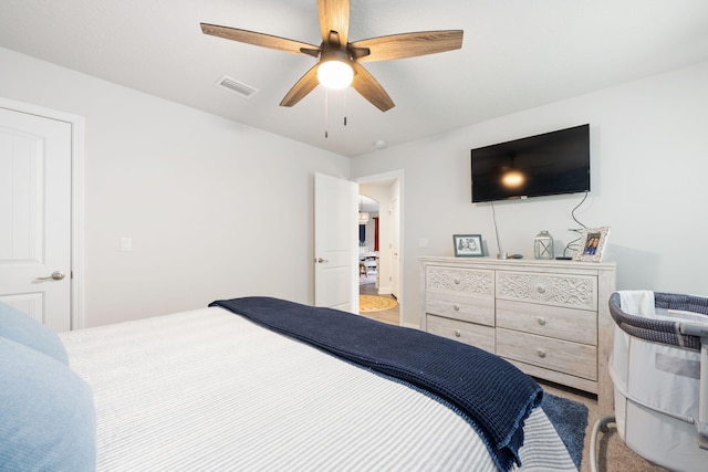 bedroom with light carpet, ceiling fan, and visible vents