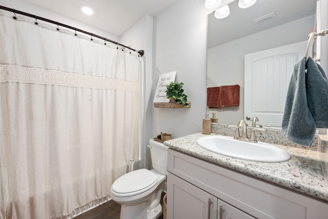 full bath featuring curtained shower, visible vents, toilet, vanity, and wood finished floors