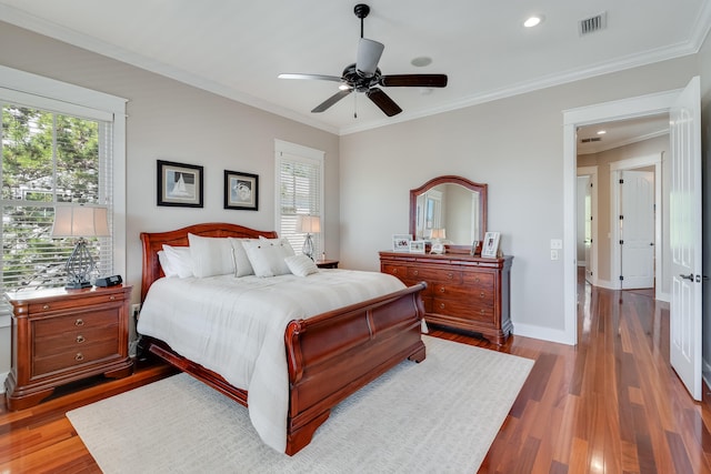 bedroom featuring multiple windows, wood finished floors, and visible vents