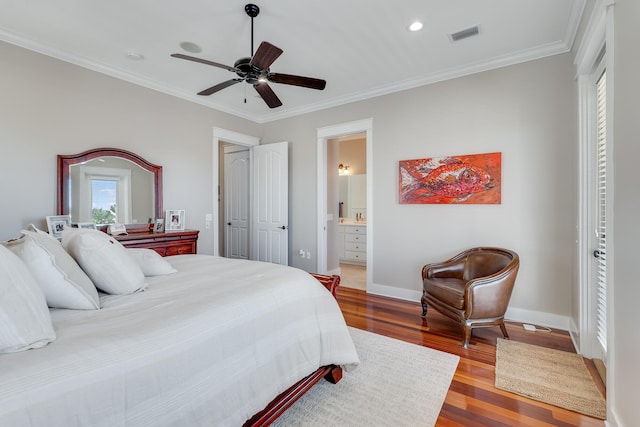 bedroom with baseboards, visible vents, connected bathroom, ornamental molding, and wood finished floors