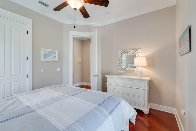 bedroom featuring crown molding, visible vents, dark wood-type flooring, ceiling fan, and baseboards