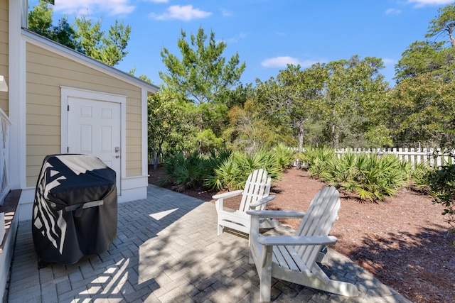 view of patio featuring area for grilling and fence