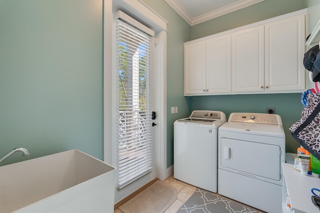 washroom with cabinet space, light tile patterned floors, washer and clothes dryer, ornamental molding, and a sink