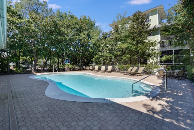 pool featuring a patio area and fence