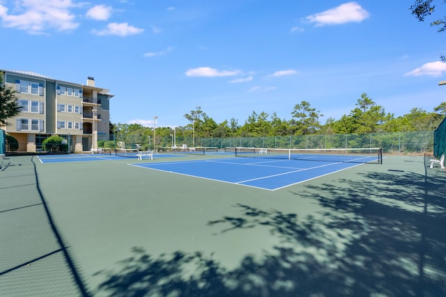 view of tennis court with fence