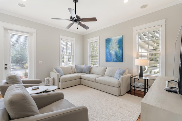 living area with recessed lighting, wood finished floors, a ceiling fan, and crown molding