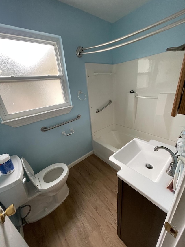 full bath with baseboards, vanity, toilet, and wood finished floors