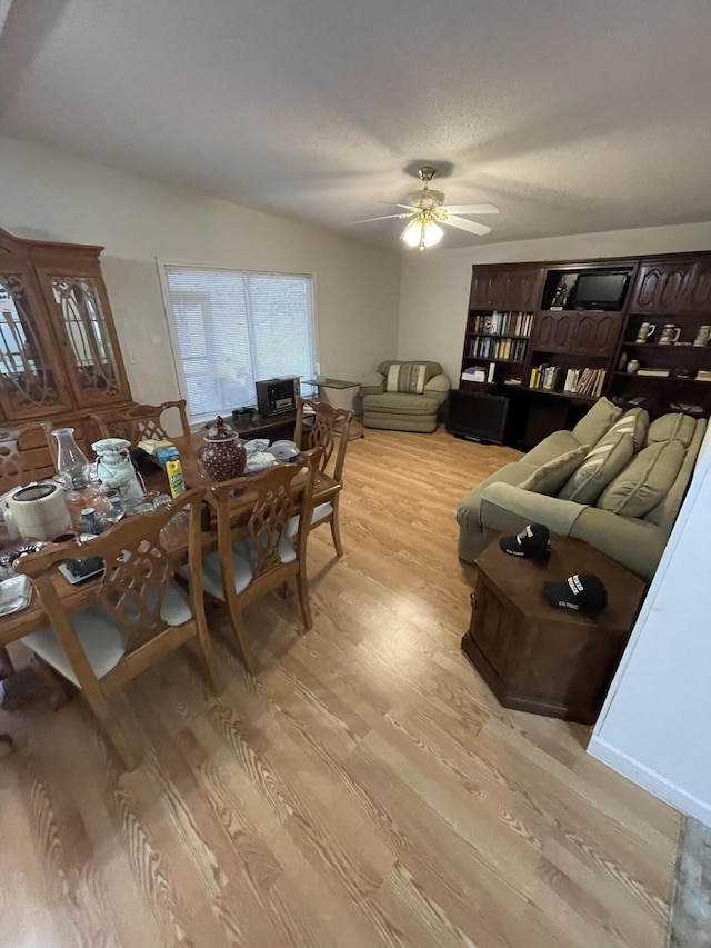 dining room featuring a ceiling fan and light wood-style floors