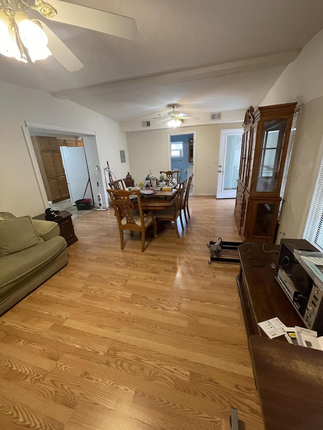 dining room featuring ceiling fan, light wood finished floors, and visible vents