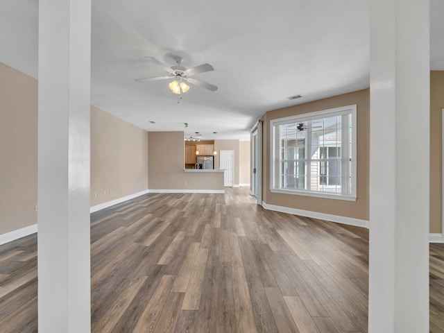 unfurnished living room with ceiling fan and hardwood / wood-style floors