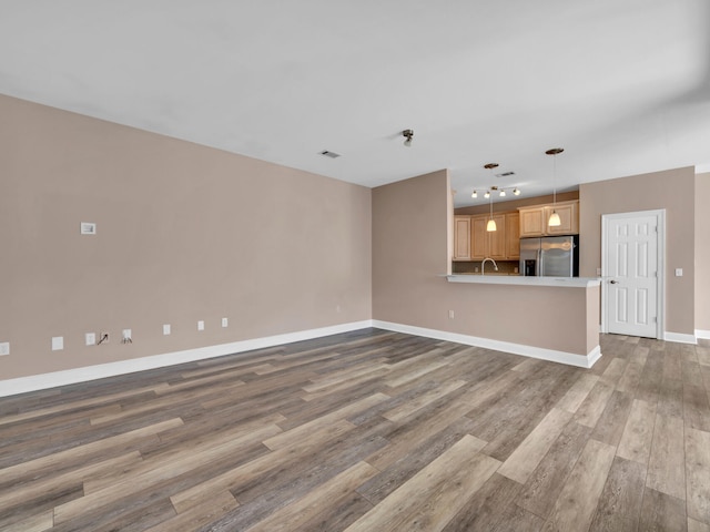 unfurnished living room featuring wood-type flooring