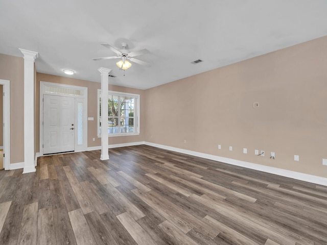 unfurnished living room with decorative columns, ceiling fan, and wood-type flooring