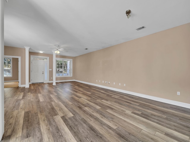 interior space with ceiling fan, light hardwood / wood-style flooring, and decorative columns