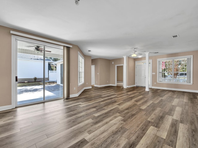 unfurnished living room featuring ornate columns, hardwood / wood-style floors, and ceiling fan