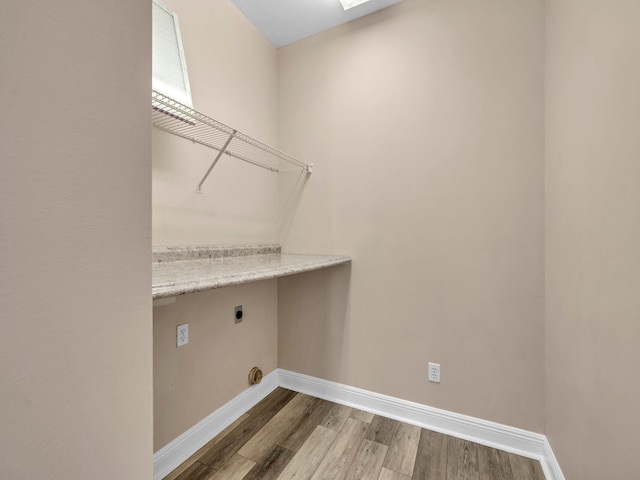 laundry room with hardwood / wood-style floors and hookup for an electric dryer