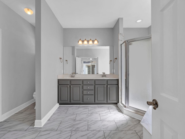 bathroom with vanity, a shower with door, and toilet