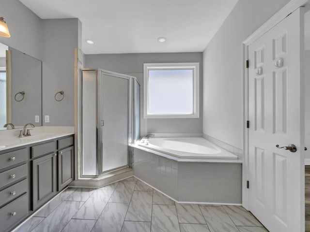 bathroom with separate shower and tub and vanity