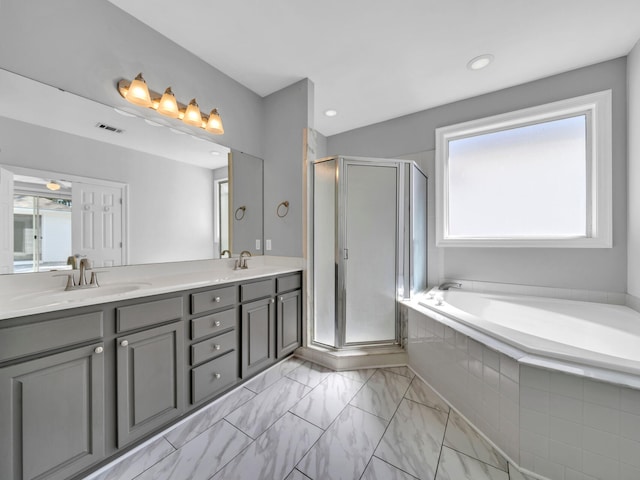 bathroom featuring separate shower and tub and vanity