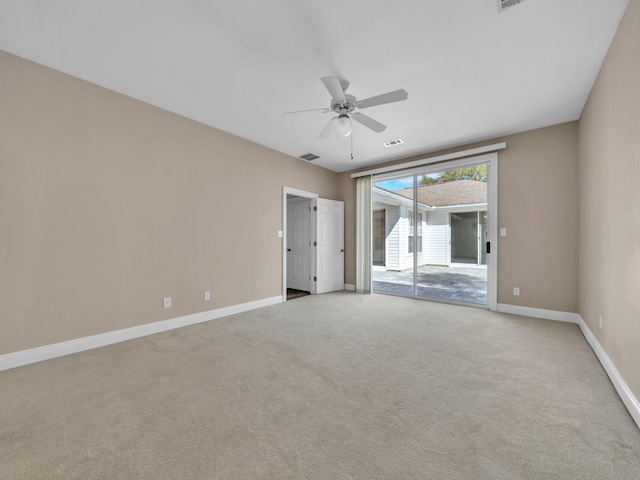 empty room with ceiling fan and light carpet