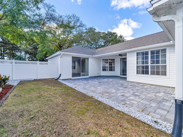 back of house with a patio area, a lawn, and ceiling fan