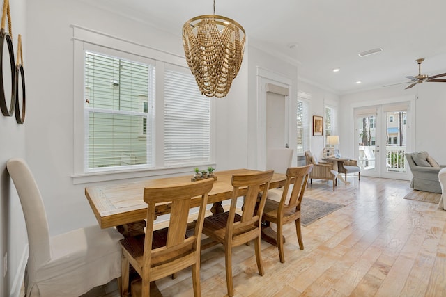 dining room featuring visible vents, light wood-style flooring, crown molding, french doors, and recessed lighting