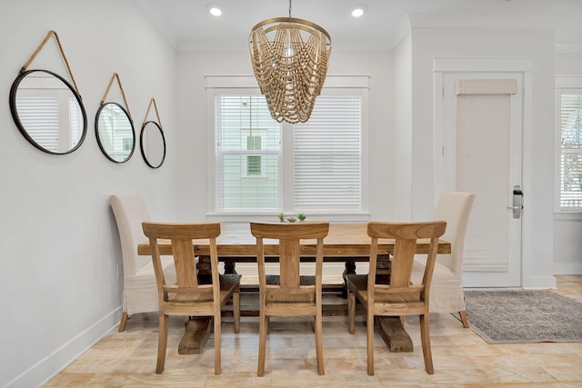 dining room with a chandelier, ornamental molding, recessed lighting, and baseboards