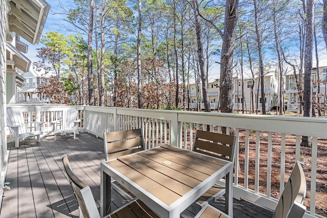 deck featuring a residential view and outdoor dining area