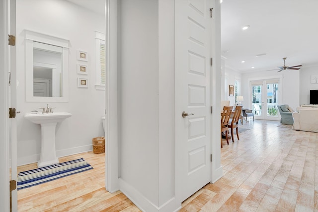 hall featuring light wood-style floors, recessed lighting, french doors, and baseboards