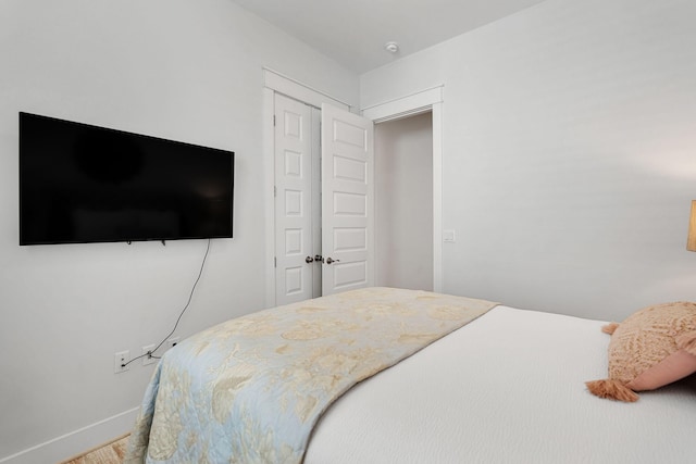 bedroom featuring a closet and baseboards