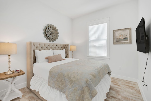 bedroom featuring light wood-type flooring and baseboards