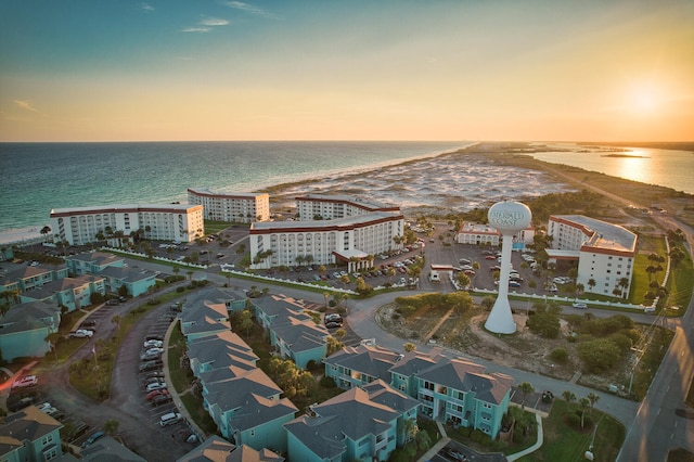 aerial view at dusk featuring a water view and a view of city