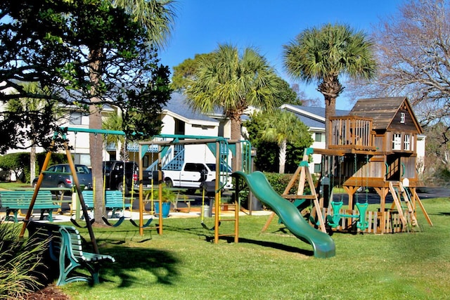 community jungle gym with a lawn