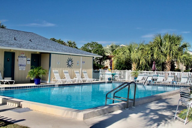 pool with fence and a patio