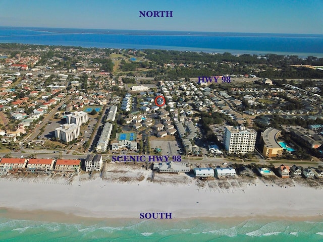 bird's eye view with a view of the beach, a water view, and a city view