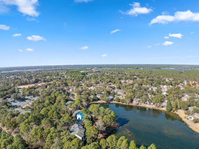 aerial view with a water view and a forest view