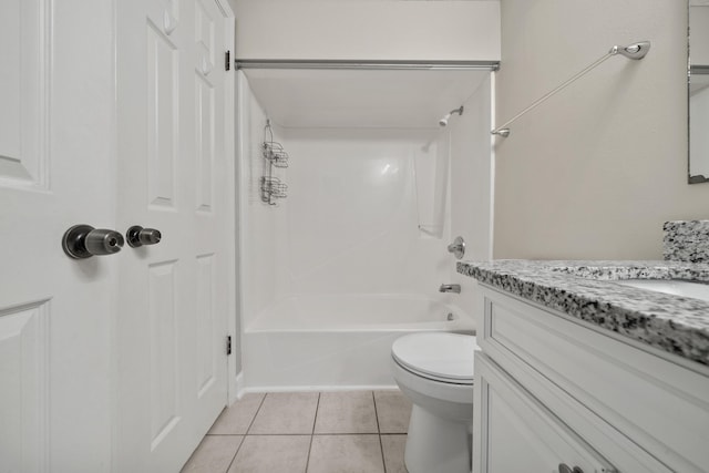 bathroom with washtub / shower combination, toilet, vanity, and tile patterned floors