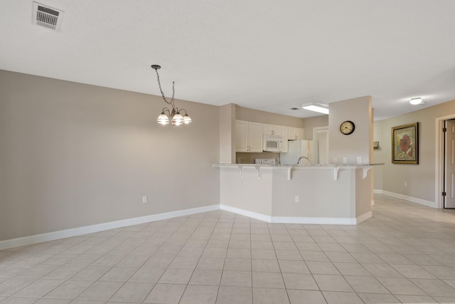 interior space with visible vents, a notable chandelier, baseboards, and light tile patterned floors