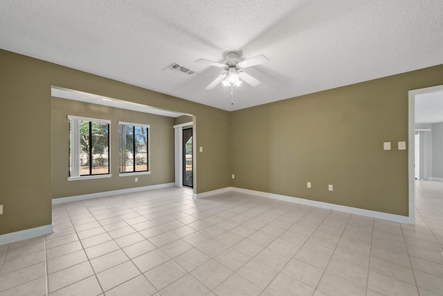 unfurnished room with light tile patterned floors, ceiling fan, a textured ceiling, and visible vents