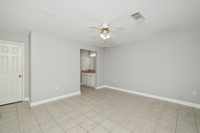 303 Southlake Ct Unit 303, Niceville, FL 32578 - spare room with ceiling fan, light tile patterned floors, a textured ceiling, and baseboards
